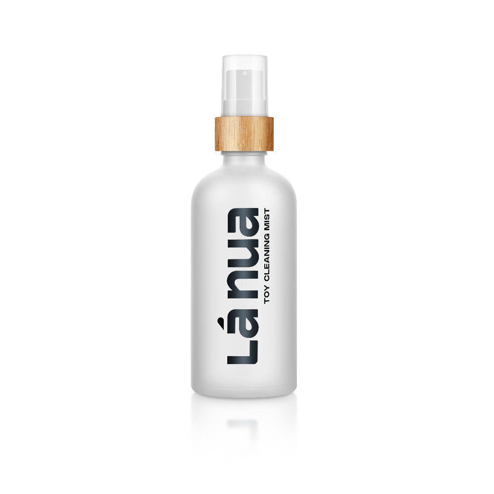 White spray bottle with gold cap labeled Lánua toy cleaning mist on a white background