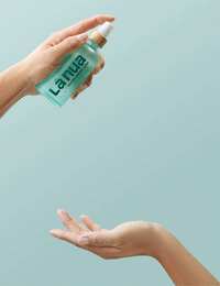 one hand pumping water based lube onto another hand with a blue background