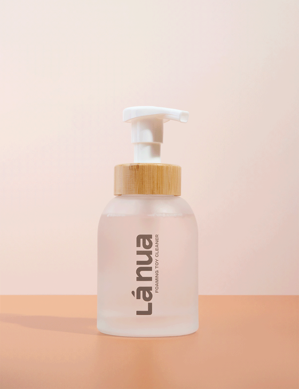 handing pumping a sex toy cleaner foaming bottle with bamboo and glass bottle