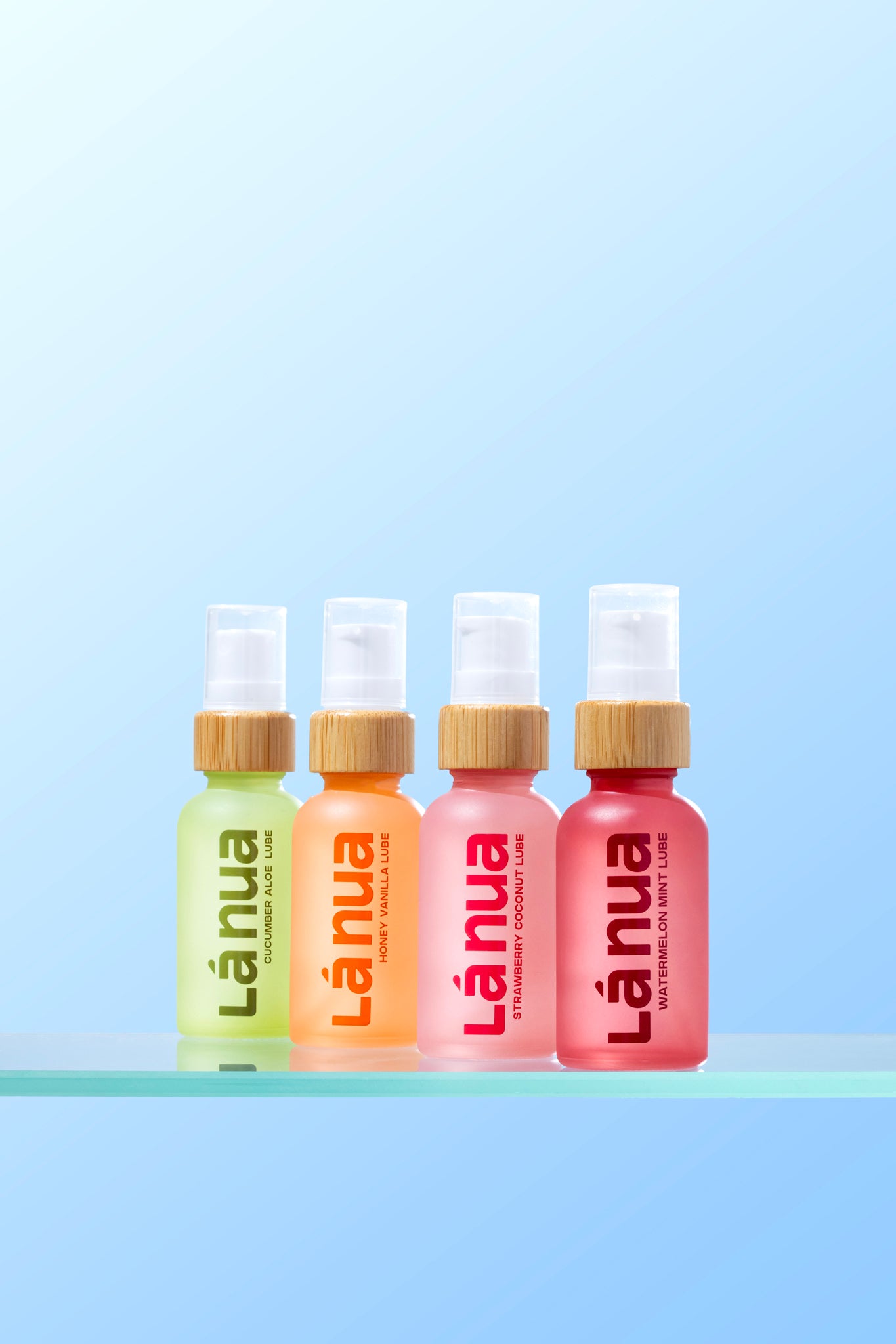 Four bottles of Lánua flavored lubes on a light blue background