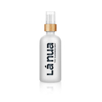 White spray bottle with gold cap labeled Lánua toy cleaning mist on a white background